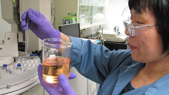 An Aerojet Rocketdyne technician handles the green propellant, which space officials hope could replace the toxic fuel hydrazine.