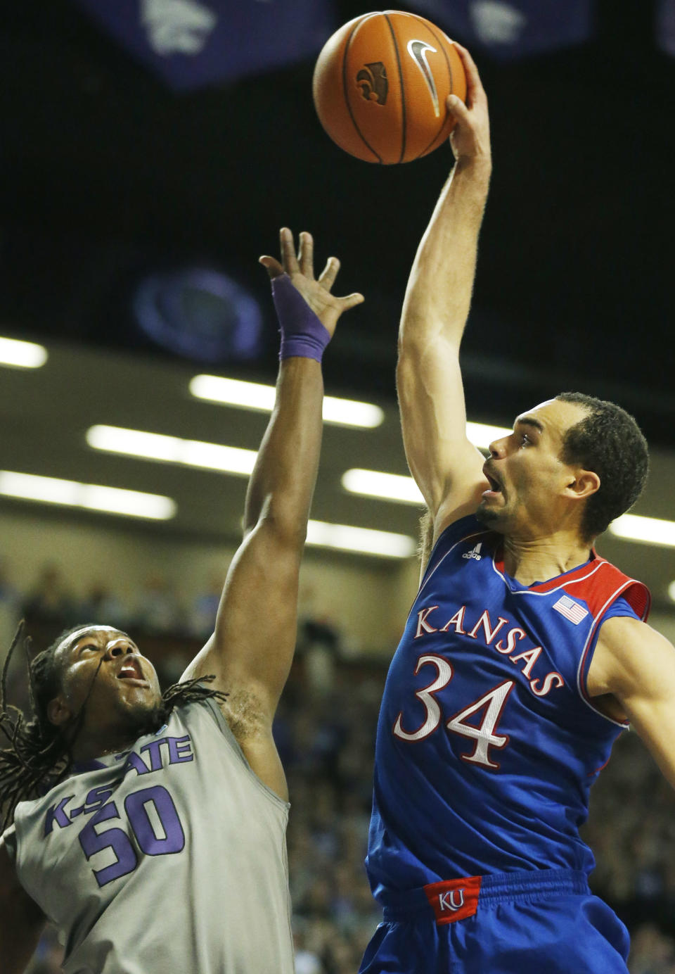 Kansas forward Perry Ellis (34) tries to dunk over Kansas State forward D.J. Johnson (50) during the first half of an NCAA college basketball game in Manhattan, Kan., Monday, Feb. 10, 2014. (AP Photo/Orlin Wagner)