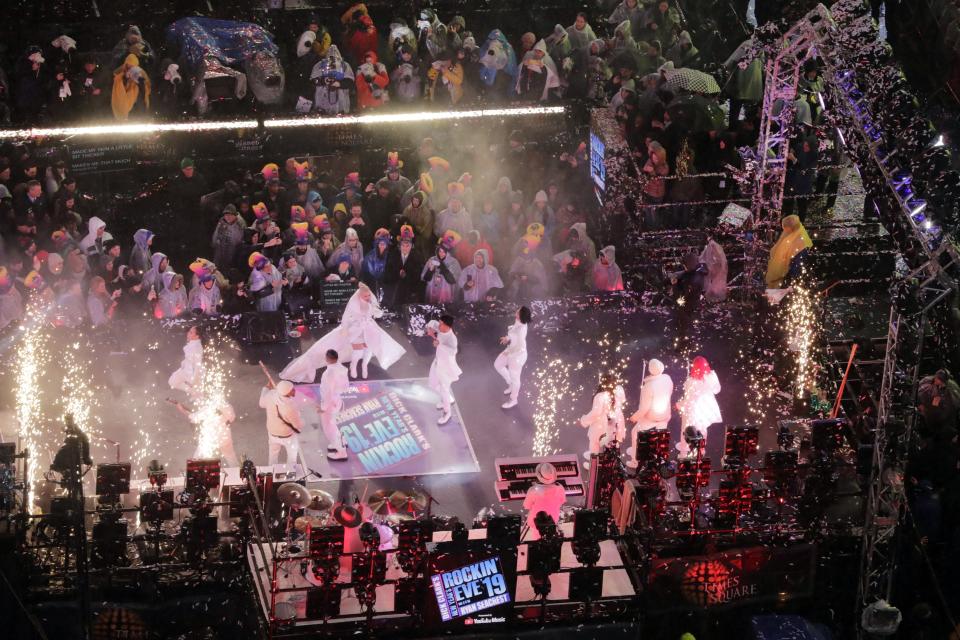 Revelers watch Christina Aguilera perform as they wait for midnight during the New Year's Eve celebration in New York's Times Square as seen from above from the Marriott Marquis hotel, Monday, Dec. 31, 2018, in New York. (AP Photo/Frank Franklin II)