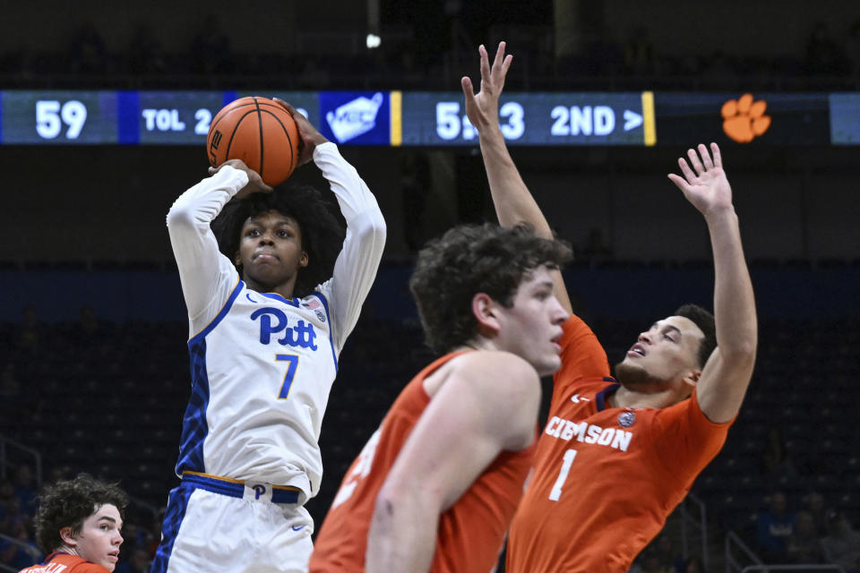 Pittsburgh guard Carlton Carrington (7) looks to shoots over Clemson guard Chase Hunter (1) during the second half of an NCAA college basketball game, Sunday, Dec. 3, 2023, in Pittsburgh. (AP Photo/Barry Reeger)
