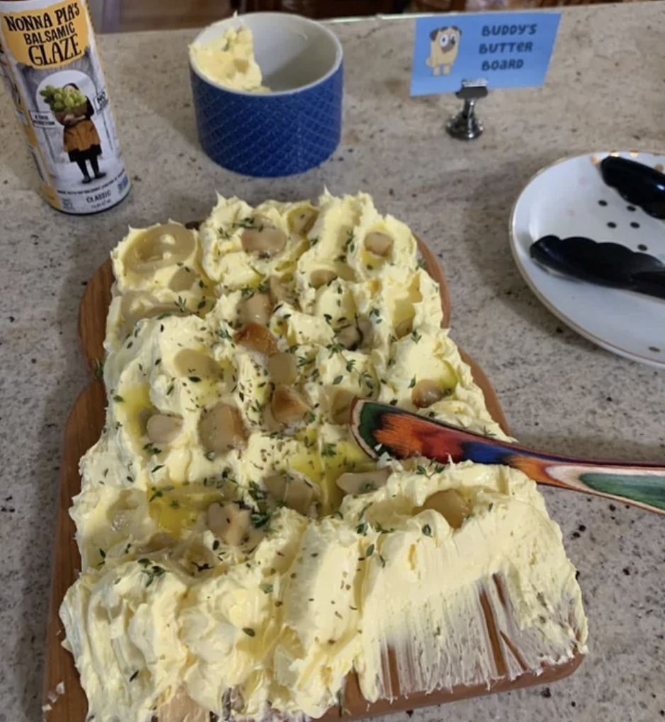 There's a board full of butter sitting on a counter