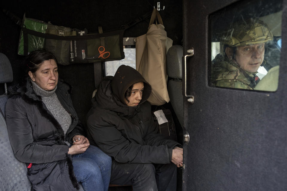 Svitlana Mazurina and her son Oleksii ride in a van during an evacuation by Ukrainian police in Avdiivka, Ukraine, Friday, March 17, 2023. “It’s hard when you’ve lived in this town from birth,” Svitlana said. “Now I’m leaving I don’t know to where, where no one needs me. I don’t know where or what to start with.” (AP Photo/Evgeniy Maloletka)