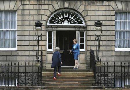 Scotland's First Minister, Nicola Sturgeon (R), greets Britain's new Prime Minister, Theresa May, as she arrives at Bute House in Edinburgh, Scotland, Britain July 15, 2016. REUTERS/Russell Cheyne