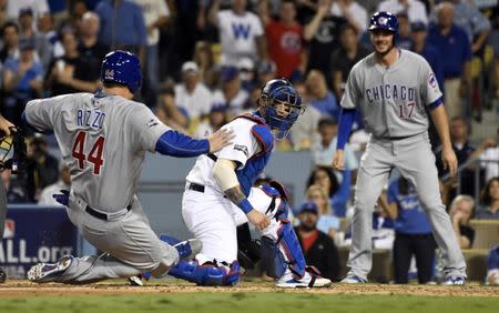 Oct 19, 2016; Los Angeles, CA, USA; Chicago Cubs first baseman Anthony Rizzo (44) scores a run past Los Angeles Dodgers catcher Yasmani Grandal in the 6th inning during game four of the 2016 NLCS playoff baseball series at Dodger Stadium. Mandatory Credit: Richard Mackson-USA TODAY Sports