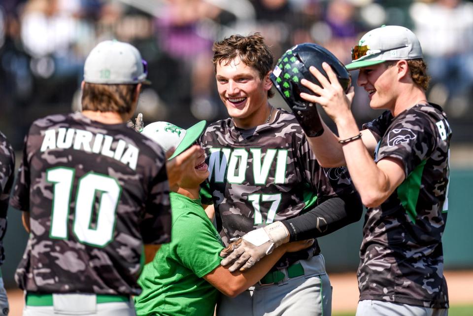 Novi's Gavin Przbyla celebrates his score against Woodhaven during the fourth inning on Saturday, June 17, 2023, at McLane Stadium on the MSU campus in East Lansing.