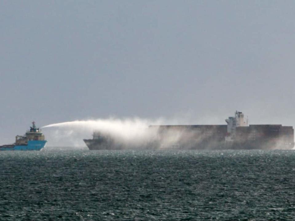 The Canadian Coast Guard says it received a call around 11 a.m. PT on Saturday about a fire that had broken out aboard the container ship Zim Kingston. (Michael Mcarthur/Submitted - image credit)