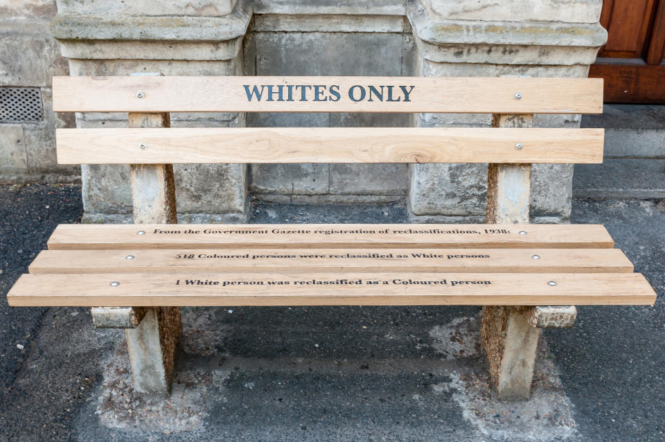 Cape Town, South Africa - December 18, 2014: Reconstructed apartheid bench in front of the High Court building explaining the race re-classification act of 1938