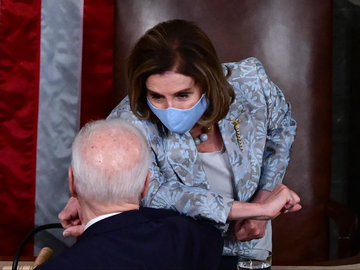 Speaker Nancy Pelosi and President Joe Biden bump elbows after he addressed a joint session of Congress on April 28, 2021.  (POOL/AFP via Getty Images)