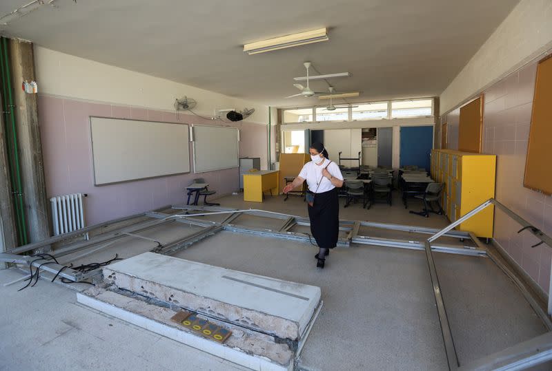 Sister Magida Fheili shows the damage inside the College Notre Dame de Nazareth in Beirut