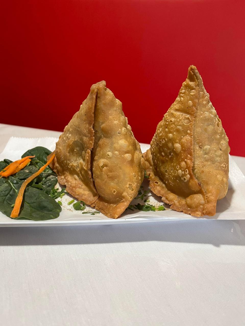 Deep-fried vegetable samosas at The Spice Delight are giant.