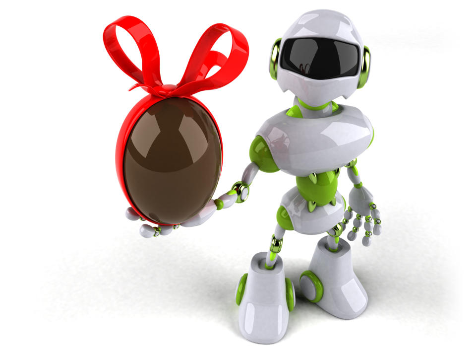 A robot holding a brown Easter egg with a red bow on it.