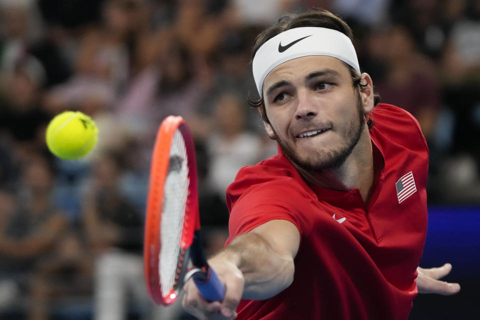 FILE - Taylor Fritz plays a backhand return to Italy's Matteo Berrettini during the final of the United Cup tennis event in Sydney, Australia, Sunday, Jan. 8, 2023. The 2023 Grand Slam season begins at the Australian Open next week. (AP Photo/Mark Baker, File)