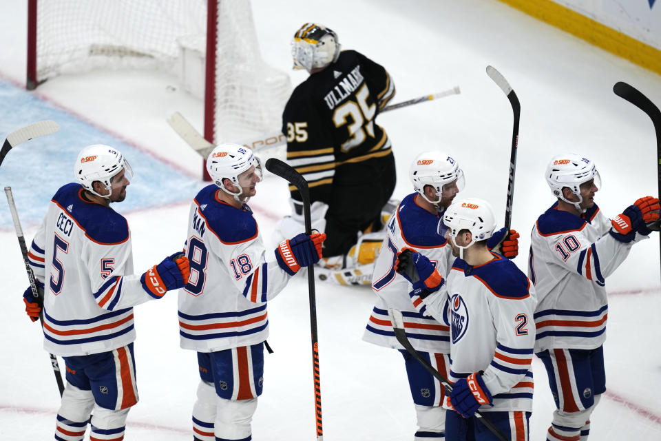 Edmonton Oilers celebrate after defeating the Boston Bruins in overtime during an NHL hockey game Tuesday, March 5, 2024, in Boston. At rear is Bruins goaltender Linus Ullmark. (AP Photo/Charles Krupa)