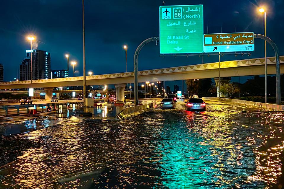 Motorists drive along a flooded street after heavy rain in Dubai early on April 17, 2024.