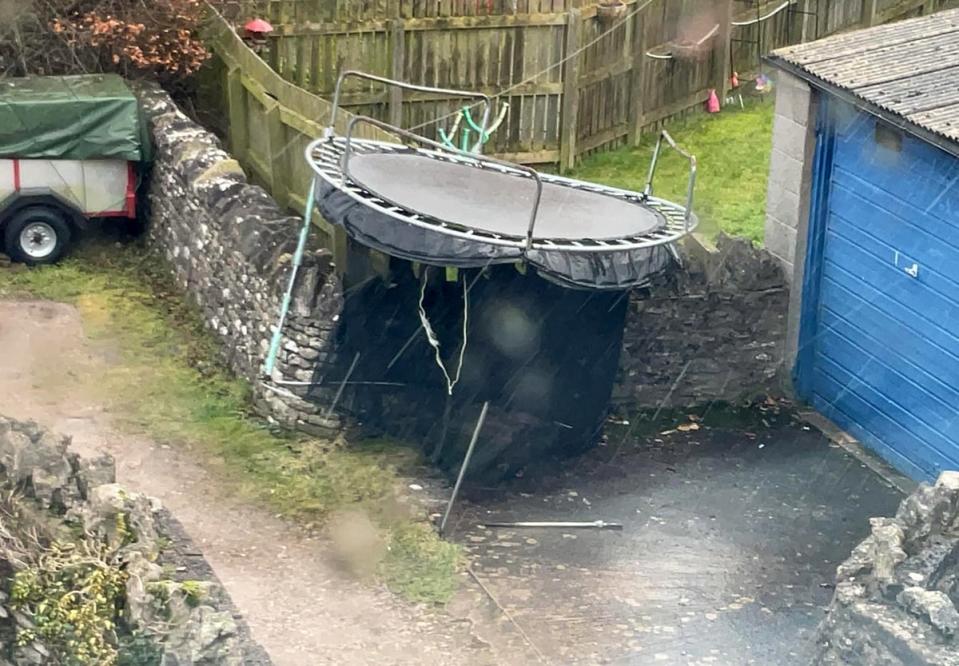 A  trampoline deposited on a wall in Kirkby Stephen, Cumbria, after gusts from Storm Isha removed it from a nearby in a garden (PA)
