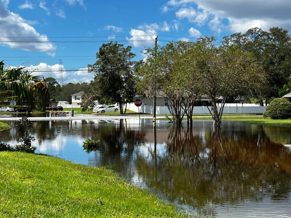 The view of Forth Smith Boulevard from a home in the 3600 block of Sunday Drive on Monday afternoon showed a still-flooded residential roadway.