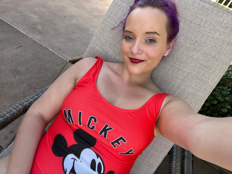 jenna posing for a selfie wearing a mickey mouse tank top on a pool lounger at the grand floridian