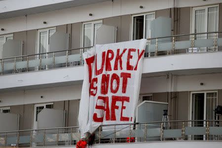 A banner hung by activists on a hotel reads "Turkey is not safe" during a protest against the return of migrants to Turkey, at the port of Mytilene on the Greek island of Lesbos, April 4, 2016. REUTERS/Giorgos Moutafis