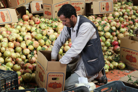 A worker packs pomegranates for export in Saada, Yemen September 25, 2018. Picture taken September 25, 2018. REUTERS/Naif Rahma