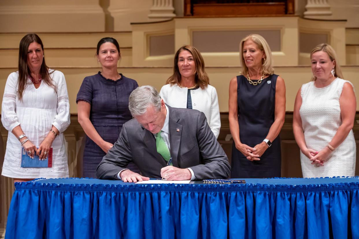 Gov. Charlie Baker signs H. 4555, An Act relative to the creation of a Women’s Rights History Trail, during a ceremonial bill signing Thursday at Mechanics Hall.