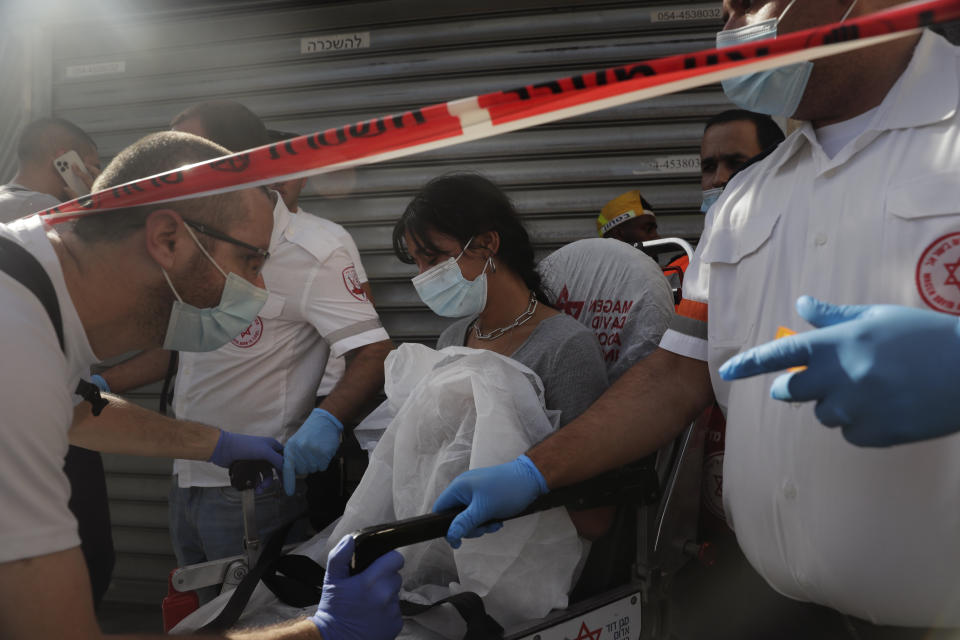 Israeli medics evacuate a woman from the site of a stabbing attack in Jerusalem's Central Bus Station Monday, Sept. 13, 2021. Israeli paramedics treated two people who were stabbed near Jerusalem's Central Bus Station by a suspected Palestinian assailant on Monday. (AP Photo/Maya Alleruzzo)