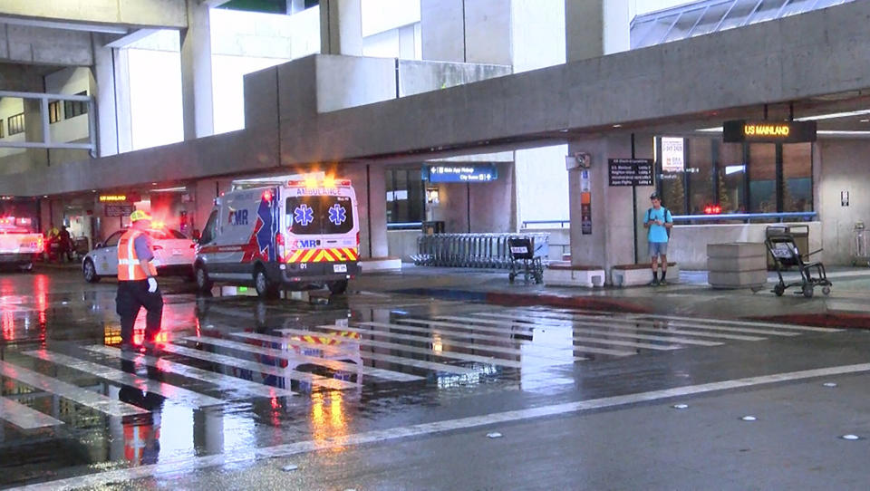 This image taken from video provided by Hawaii News Now shows the scene outside the international airport in Honolulu after nearly a dozen people were seriously injured when a flight to Hawaii hit severe turbulence on Sunday, Dec. 18, 2022. (Hawaii News Now via AP)