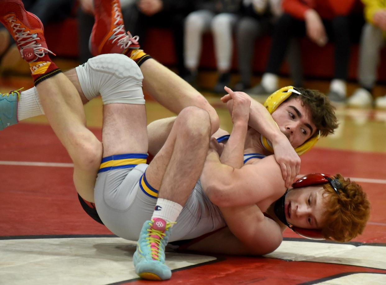 Ty Rose of Jefferson (top) and New Boston Huron's Daniel Gemmel tangle in a dual meet on Jan. 24. Rose won a championship to help Jefferson win the Huron League meet Saturday.