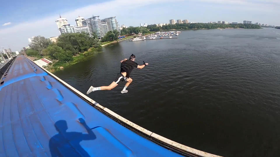 This heart-stopping footage shows a daredevil jumping from a speeding train into a river below. Yaro Panchenko, 18, is seen 'surfing' the subway car as it moves through his home town of Kiev in the Ukraine on August 1 this year. Not content with just surfing the train, Yaro then leaps from the carriage as it crosses a bridge into the water below. However, it didn't go entirely to plan as his Go Pro camera hit him in the face on impact and knocked out a tooth.