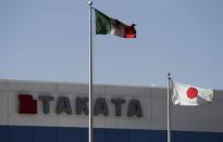 The Mexican and the Japanese national flags are seen outside the Takata plant in Monclova in this April 11, 2013 file photo. REUTERS/Daniel Becerril/Files