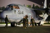 U.S. Marines from the 3rd Marine Expeditionary Brigade on two KC-130J Super Hercules aircraft arrive at Villamor Air Base, in Pasay city, metro Manila November 10, 2013 in this handout provided by U.S. Marine Corps. A team of about 90 U.S. Marines and sailors headed to the Philippines on Sunday, part of a first wave of promised U.S. military assistance for relief efforts after a devastating typhoon killed at least 10,000 people, U.S. officials said. Defense Secretary Chuck Hagel this weekend ordered the U.S. military's Pacific Command to assist with search and rescue operations and provide air support in the wake of super typhoon Haiyan, one of the most powerful storms ever recorded. Picture taken November 10, 2013. REUTERS/Capt. Joshua Diddams/U.S. Marine Corps/Handout via Reuters ATTENTION EDITORS - THIS IMAGE HAS BEEN SUPPLIED BY A THIRD PARTY. FOR EDITORIAL USE ONLY. NOT FOR SALE FOR MARKETING OR ADVERTISING CAMPAIGNS. IT IS DISTRIBUTED, EXACTLY AS RECEIVED BY REUTERS, AS A SERVICE TO CLIENTS