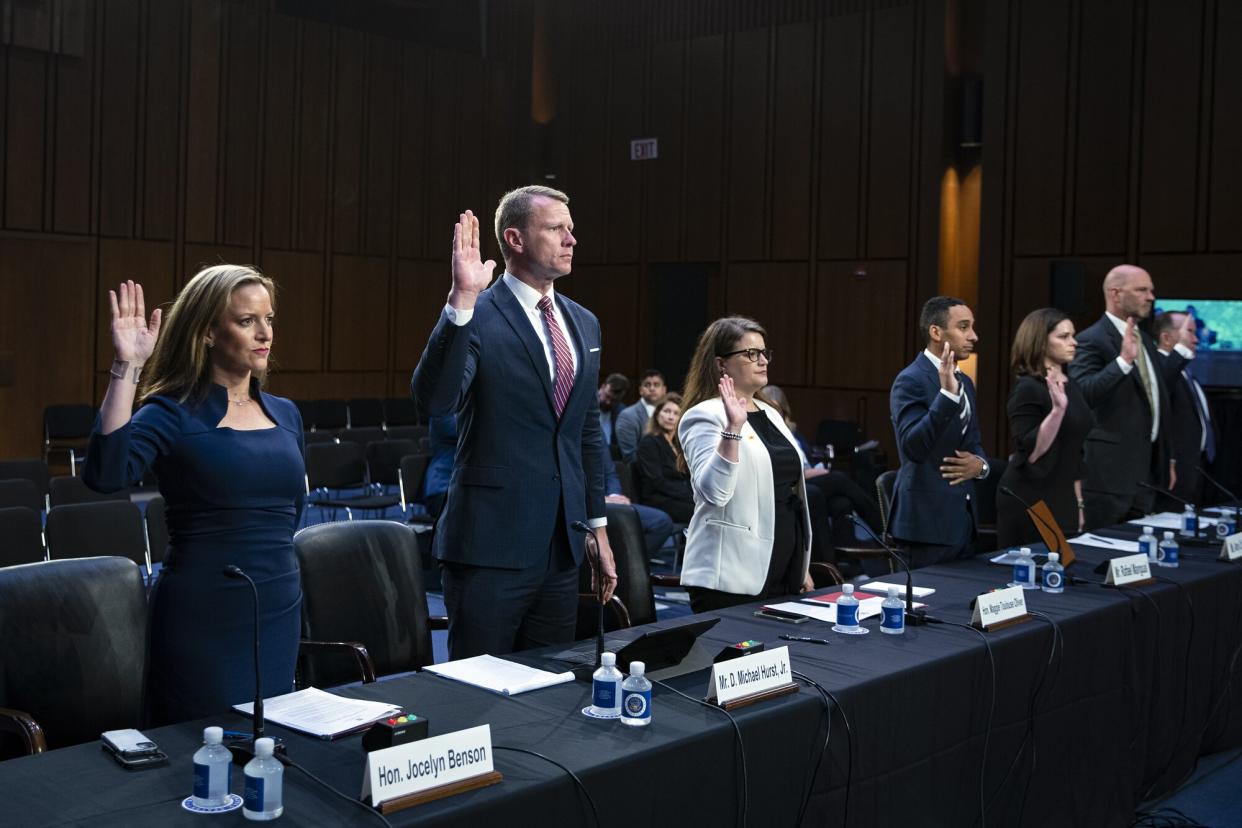 Jocelyn Benson, Michigan secretary of state, left, is sworn-in during a Senate Judiciary Committee hearing in Washington, D.C., US, on Wednesday, Aug. 3, 2022. Federal prosecutors have charged five people with threatening election workers since the Justice Department launched a task force on the issue last summer, according to testimony prepared for the committee hearing.