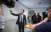 Netherlands Prime Minister Mark Rutte takes a photo on a phone at a polling station in The Hague, Netherlands, Thursday, May 23, 2019, as polls opened in elections for the European Parliament. (AP Photo/Phil Nijhuis)