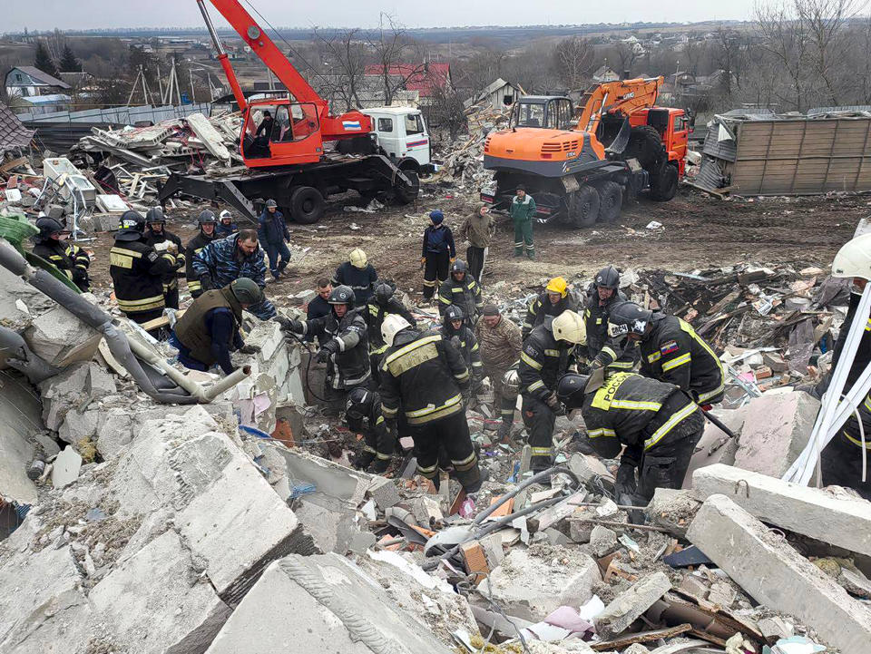 This photo released by Belgorod region governor Vyacheslav Gladkov's telegram channel on Monday, March 18, 2024, shows emergency ministry employees working at the destroyed building after shelling from the Ukrainian side, in Nikolskoye village, Belgorod region, Russia. Belgorod region governor Vyacheslav Gladkov says four people were killed in the shelling, not far from the border with Ukraine. (Belgorod Region Governor Vyacheslav Gladkov telegram channel via AP)