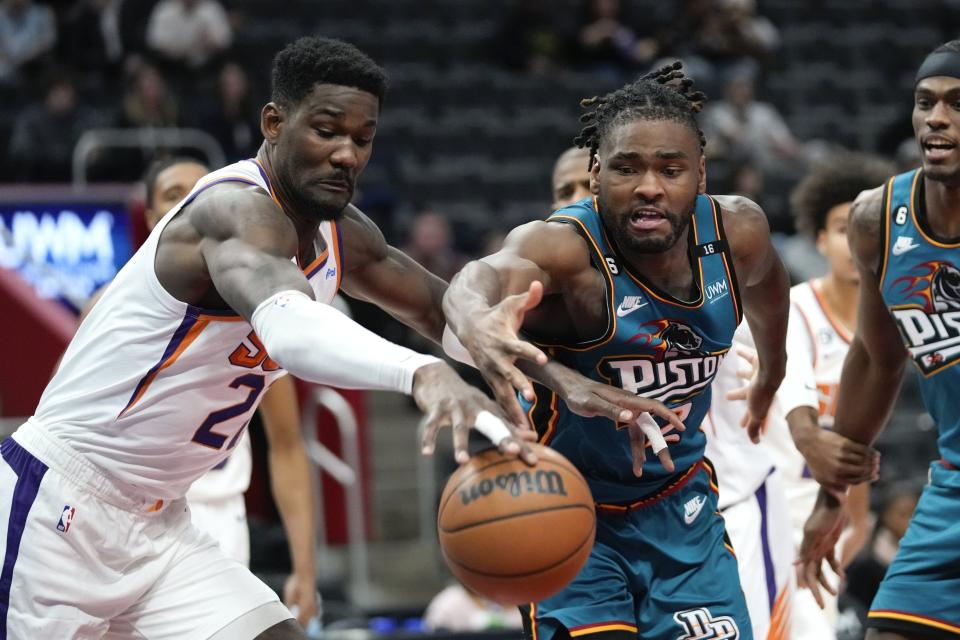 Phoenix Suns center Deandre Ayton (22) and Detroit Pistons center Isaiah Stewart (28) chase a loose ball in the second half at Little Caesars Arena in Detroit on Saturday, Feb.  4, 2023.