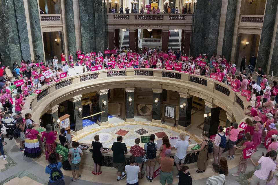 Dozens of protesters gather in the Wisconsin state Capitol rotunda in Madison, Wis. Wednesday, June 22, 2022, in hopes of convincing Republican lawmakers to repeal the state's 173-year-old ban on abortions. The ban has been dormant since the U.S. Supreme Court handed down its landmark Roe v. Wade decision in 1973 but the court is expected to overturn that ruling any day. That would reactivate Wisconsin's ban. Democratic Gov. Tony Evers called a special legislative session Wednesday afternoon to repeal the ban but Republicans control the Legislature and were expected to gavel in and gavel out without taking any action. (AP Photo/Todd Richmond)