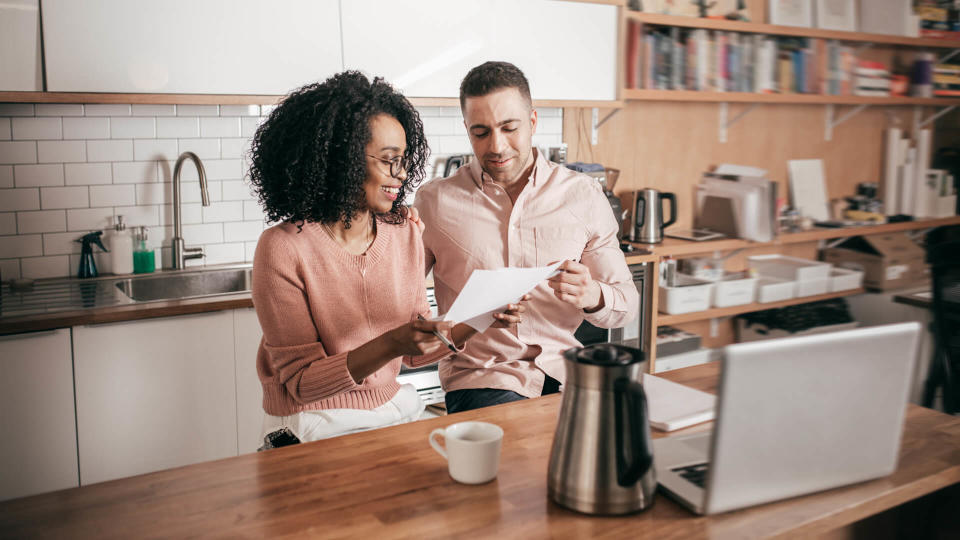 Couple planning their finances on the kitchen.