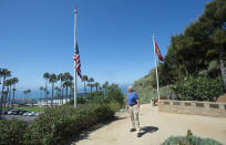 Former San Clemente Mayor Wayne Eggleston looks back after lowering the U.S. flag to half-staff at Park Semper Fi in San Clemente, Calif., on Friday, July 31, 2020. An amphibious assault vehicle carrying multiple Marines and a Navy sailor sank near a military-owned island off the coast of Southern California on Thursday. (Paul Bersebach/The Orange County Register via AP)