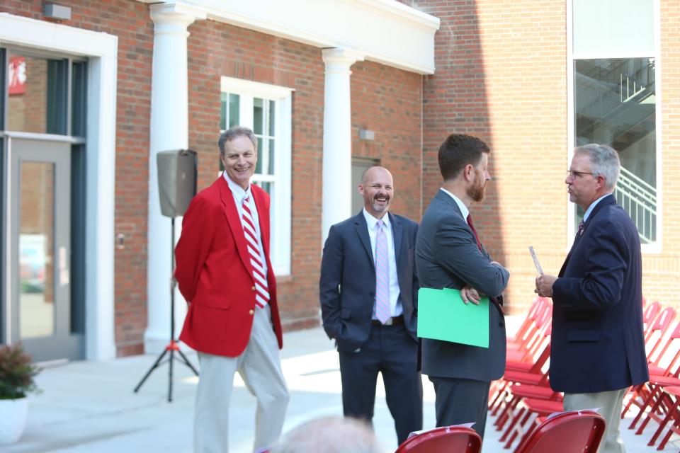 Hendersonville High School Principal Bobby Wilkins, left, shares a laugh with Henderson County Public Schools' Carl Taylor as Henderson County Manager John Mitchell talks with Henderson County Public Schools Assistant Superintendent Scott Rhodes.