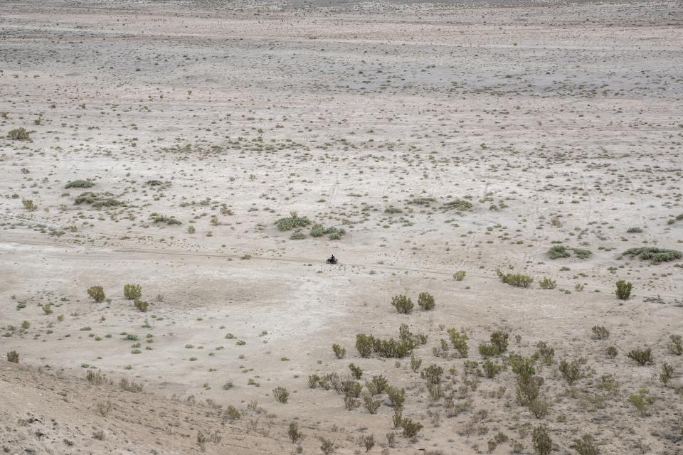 A man rides in desert that used to be a bed of the Aral Sea, outside Muynak, Uzbekistan, Saturday, June 24, 2023. (AP Photo/Ebrahim Noroozi)