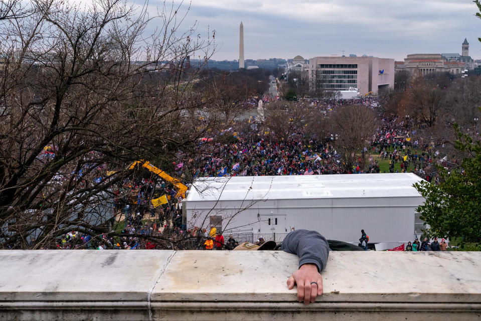 <strong>Washington, D.C., Jan. 6, 2021.</strong> "I waited with the crowd as the East doors were battered, but some militia members began to threaten another photographer and me, and we left the scene. By the time I returned to the East side, the crowd had been expelled and began taking out their anger on the media. A TV news enclosure was smashed to pieces, the crew chased off. Police reinforcements had arrived, and they slowly pushed the rioters away from the Capitol, firing tear gas, shooting pepper balls and throwing flashbangs. An angry member of the crowd yelled, 'No more back the blue! Now no one likes you,' to scattered cheers."<span class="copyright">Peter van Agtmael—Magnum Photos for TIME</span>