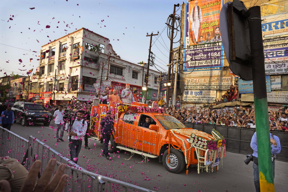 Indian Prime Minister Narendra Modi, center in a saffron cap, and Chief Minister of Uttar Pradesh Yogi Adityanath, in saffron robes, ride in an open vehicle as they campaign for Bharatiya Janata Party (BJP) for the upcoming parliamentary elections in Ghaziabad, India, April 6, 2024.India is in election mode with colorful, and frenzied, campaign underway by various political parties to woo voters across the country. From April 19 to June 1, nearly 970 million Indians or over 10% of the global population are eligible to vote in India's general election. (AP Photo/ Manish Swarup)