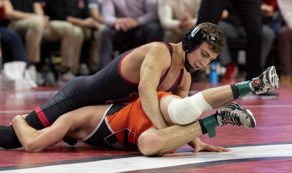 Rutgers' Joey Olivieri, (left), shown wrestling Princeton's Nick Kayal last Feb. 18, returned to Rutgers University's dual-meet lineup with a 15-2 win by major decision Friday night in the Scarlet Knights' 24-16 defeat at Indiana in their Big Ten Conference opener.