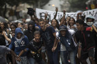 Friends and Residents of Pavao-Pavaozinho slum protest in the streets of Copacabana against the death of Douglas Rafael da Silva Pereira after his burial in Rio de Janeiro, Brazil, Thursday, April 24, 2014. The protest followed the burial of Pereira, whose shooting death sparked clashes Tuesday night between police and residents of the Pavao-Pavaozinho slum. (AP Photo/Felipe Dana)