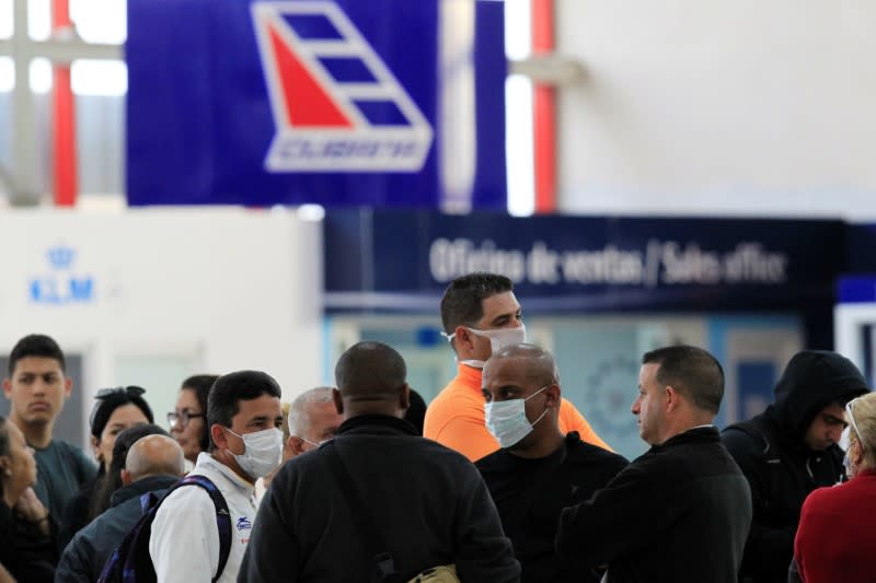 People wearing face masks are seen at Jose Marti International Airport, in Havana