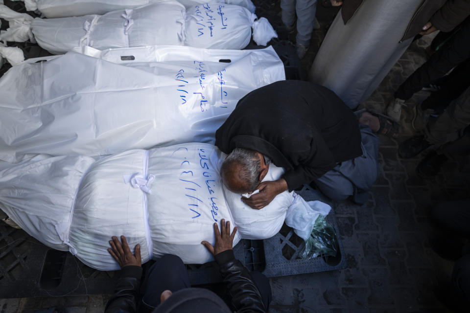 Palestinians mourn their relatives killed in the Israeli bombardment of the Gaza Strip, outside a morgue in Rafah, southern Gaza, Thursday, Jan. 18, 2024. (AP Photo/Fatima Shbair)