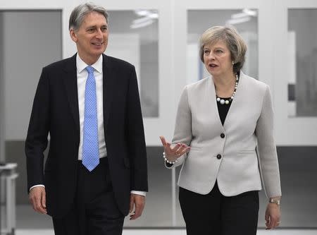 Britain's Prime Minister Theresa May and Chancellor of the Exchequer Philip Hammond tour the Renishaw innovation and engineering plant in Wootton, south west England, in Britain, November 24, 2016. REUTERS/Toby Melville