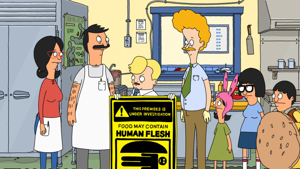 the health inspector holding a "food may contain human flesh" sign