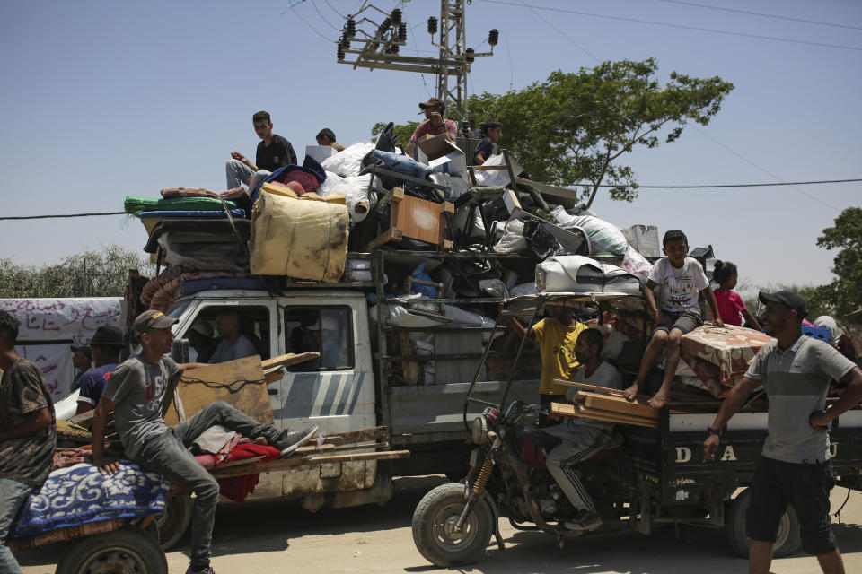 Palestinians arrive in the southern Gaza town of Khan Younis after fleeing an Israeli ground and air offensive in the nearby city of Rafah on Friday, June 28, 2024. (AP Photo/Jehad Alshrafi)