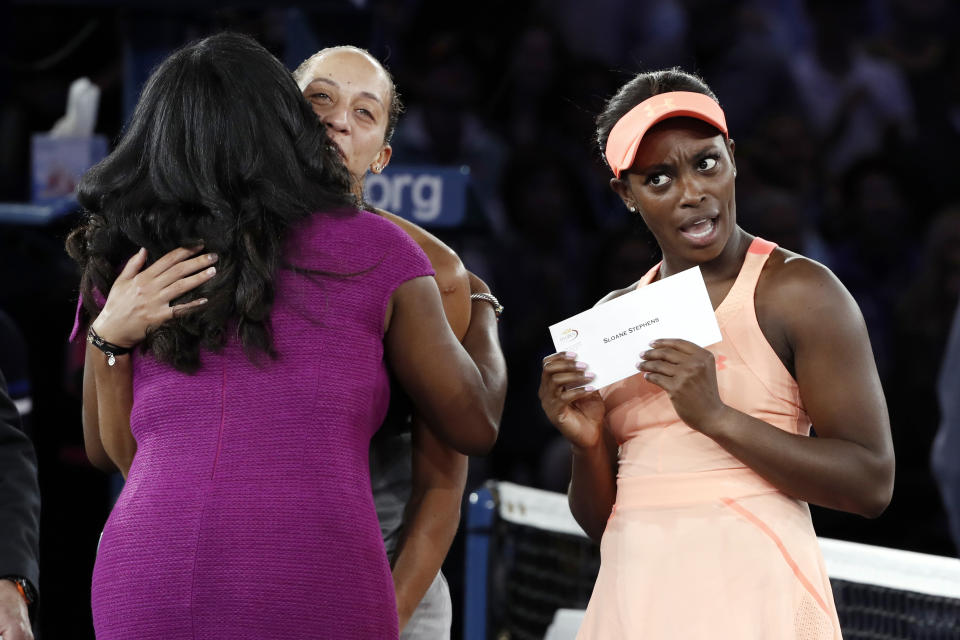 FILE - In this Sept. 9, 2017, file photo, Sloane Stephens, of the United States, reacts after receiving the winner's award check after beating Madison Keys, of the United States, in the women's singles final at the U.S. Open tennis tournament in New York. Despite a loss in revenue from holding its marquee event without spectators amid the coronavirus pandemic, the U.S. Tennis Association announced Wednesday, Aug. 5, 2020, that its overall compensation to players at this year’s U.S. Open will be $53.4 million -- which is 93.3% of the roughly $57.2 million awarded in 2019. (AP Photo/Andres Kudacki)