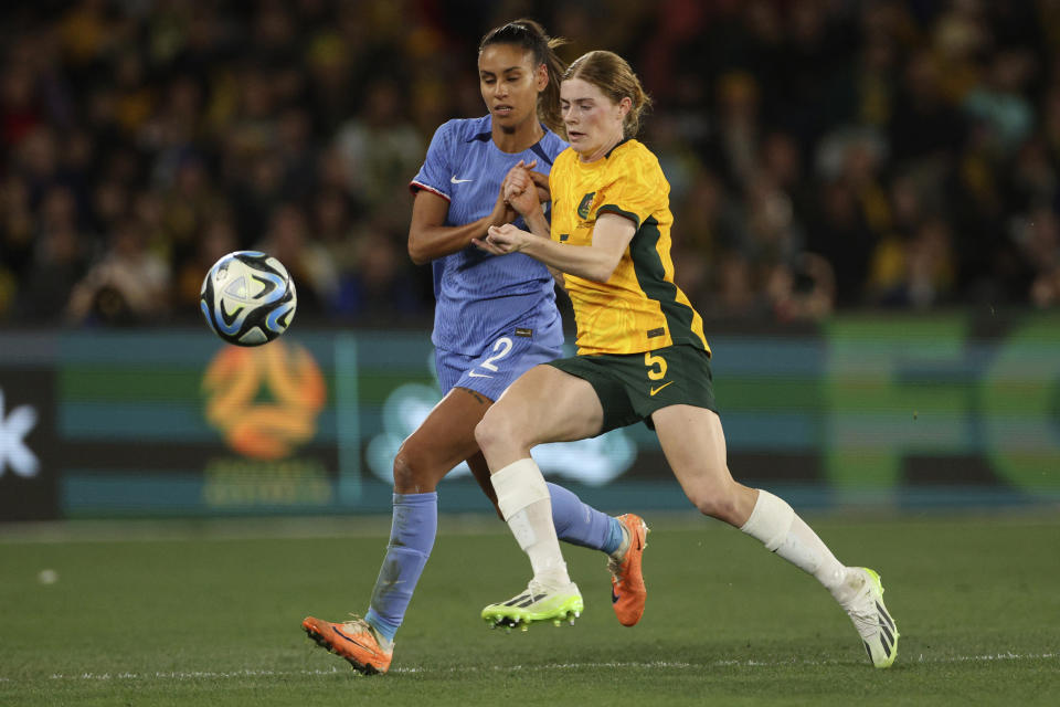 France's Maelle Lakrar, left, and Australia's Cortnee Vine compete for the ball during their friendly soccer match in Melbourne, Friday, July 14, 2023, ahead of the Women's World Cup. (AP Photo/Hamish Blair)